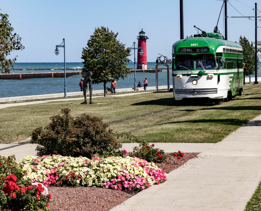 A streetcar passing by the North Pier Lighthouse in Kenosha, Wisconsin